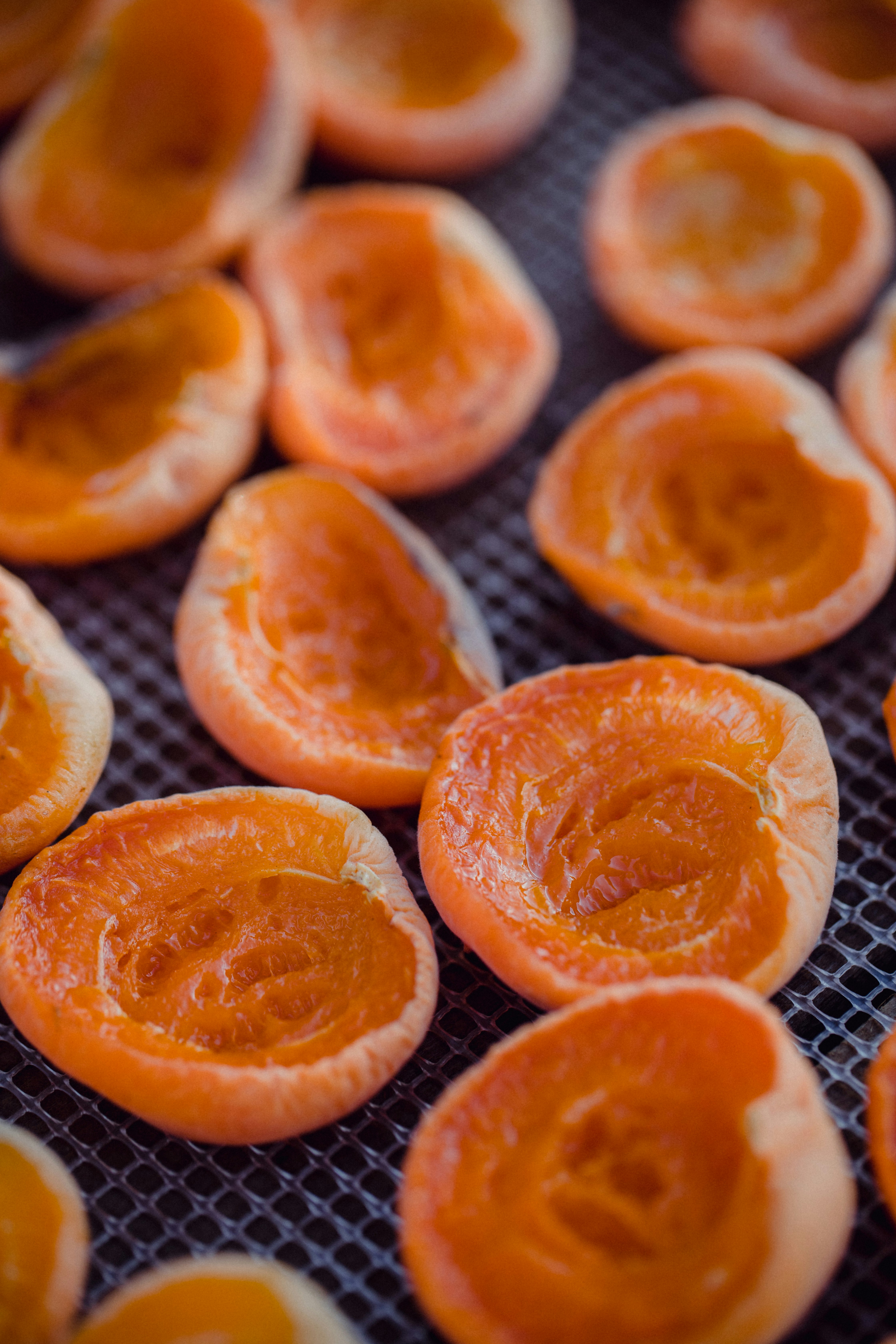 sliced orange fruit on black metal tray